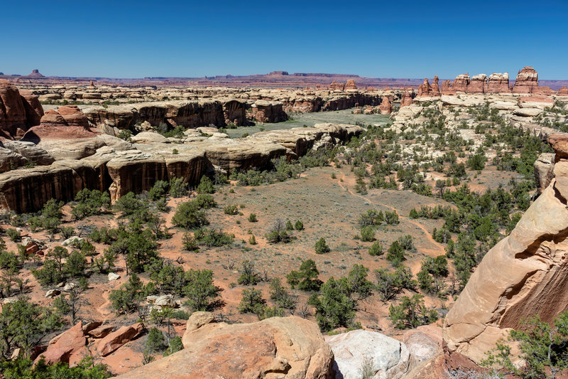 An aerial view of Devils Kitchen with the Island in the Sky on the horizon.