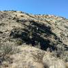 Couple of hikers beginning the climb to Rincon Ridge, on the skyline.