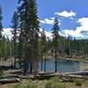 The first little lake is set in the pine forest below Bathtub Lake Trail.