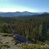 The Kings Creek Valley is below and mountains stretch forever into the distance including Mt. Hoffman, 7,833 ft., (center right). Juniper Lake is in the distance at the extreme right. Looking east from high on Kings Creek Trail.