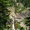 Mill Creek Falls plunges over 70 feet down in this rugged terrain.  At the top of the falls, East Sulphur Creek that is bridged on the left, collects Bumpass Creek (upper center right), and together they drop off the cliff as Mill Creek Falls.