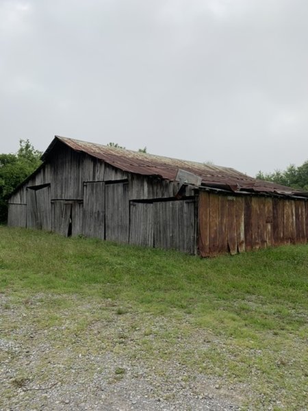 Trailhead is off to the right of the barn.