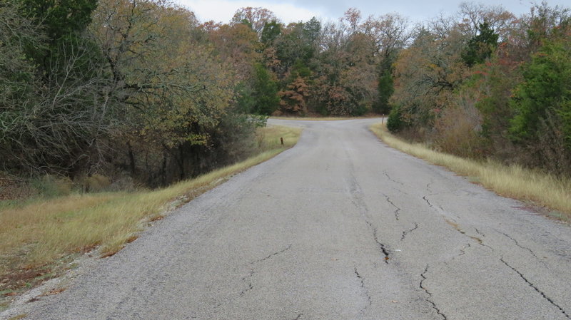 Coming to the Fork in the Road - Next you go left at the split to find the trailhead .