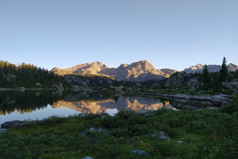 Mt. Lester's two peaks are reflected perfectly at sunrise, in the first Cook Lake.