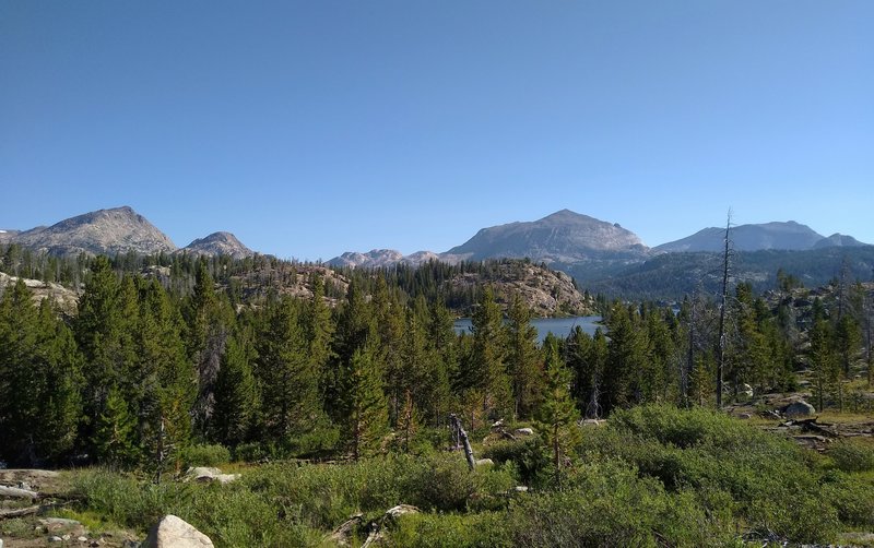 North Fork Lake is in the distance below as Highline Trail passes south of it. Mount Victor, 12,254 feet, (center right) is the prominent peak behind North Fork Lake.