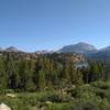 North Fork Lake is in the distance below as Highline Trail passes south of it. Mount Victor, 12,254 feet, (center right) is the prominent peak behind North Fork Lake.