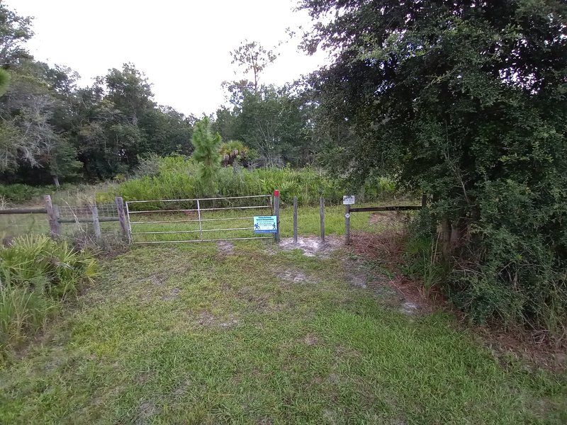 Trail starts here through opening in fence