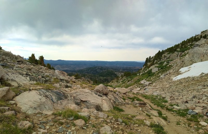 Under threatening skies, rugged foothills emerge in the view to the south from Hat Pass, along the CDT/Fremont Trail.