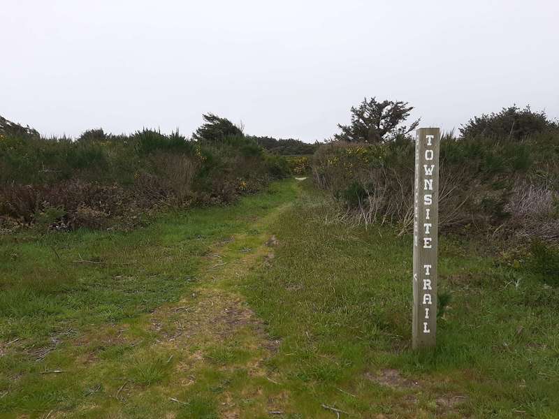 Tall wooden sign marking the trail.