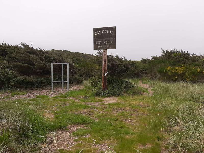 Tall wooden sign marks the center of the Bayocean Townsite.