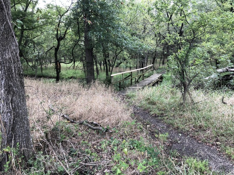 The Curly Dock Path spans a wet area with a bridge, steps and a boardwalk for connection back to Mohawk Boulevard.