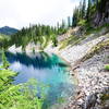 Hikers continue towards the Gem Lake Trail on the upper end of Snow Lake.