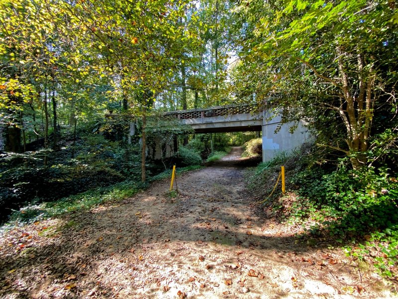 A bridge rising above the trail.