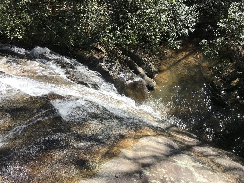 View looking down falls over open slickrock area.