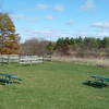 Equestrian holding area near parking lot with prairie in background.