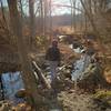 Boy crossing a small creek.