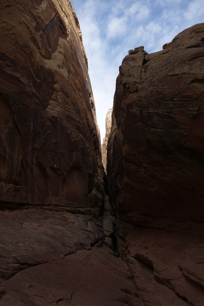 Narrow side opening in Little Wild Horse Canyon. From above the rock appears scored in the SW-NE direction every 150 feet or so.