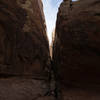 Narrow side opening in Little Wild Horse Canyon. From above the rock appears scored in the SW-NE direction every 150 feet or so.