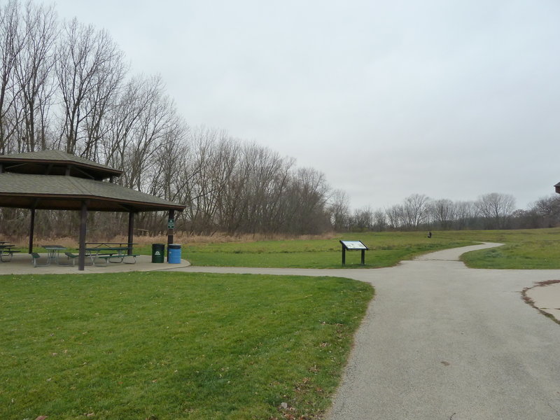 Shelter #2 with open prairie and interpretive sign.