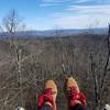 Sitting atop the rock outcrop at Mena Peak.