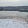 The trail opens out onto a small clearly right at the edge of Lake Jacomo providing an expansive view of the water.