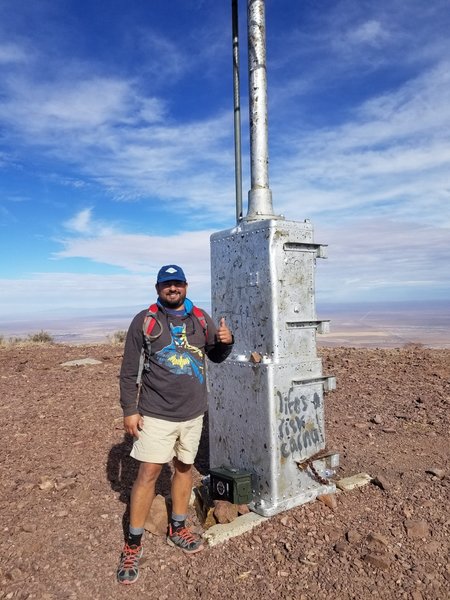 Atop the peak next to the repeater.