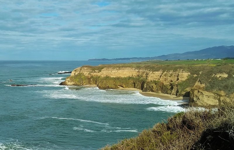 Sandstone cliffs drop to the Pacific Ocean near Half Moon Bay, seen from the bluffs of Cowell-Purisima Trail.