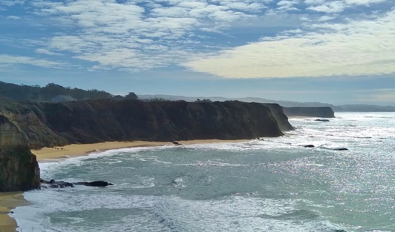 Cliffs silhouetted, and ocean shimmering in the afternoon, to the south of Cowell-Purisima Trail.