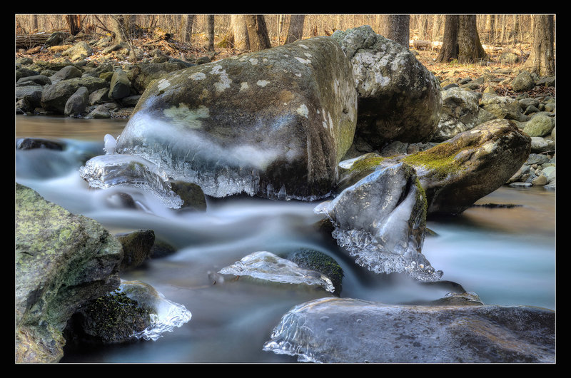 Long exposure of water flowing over the ice at Rose River.