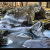 Long exposure of water flowing over the ice at Rose River.