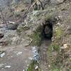 Water ditch tunnel through rock.