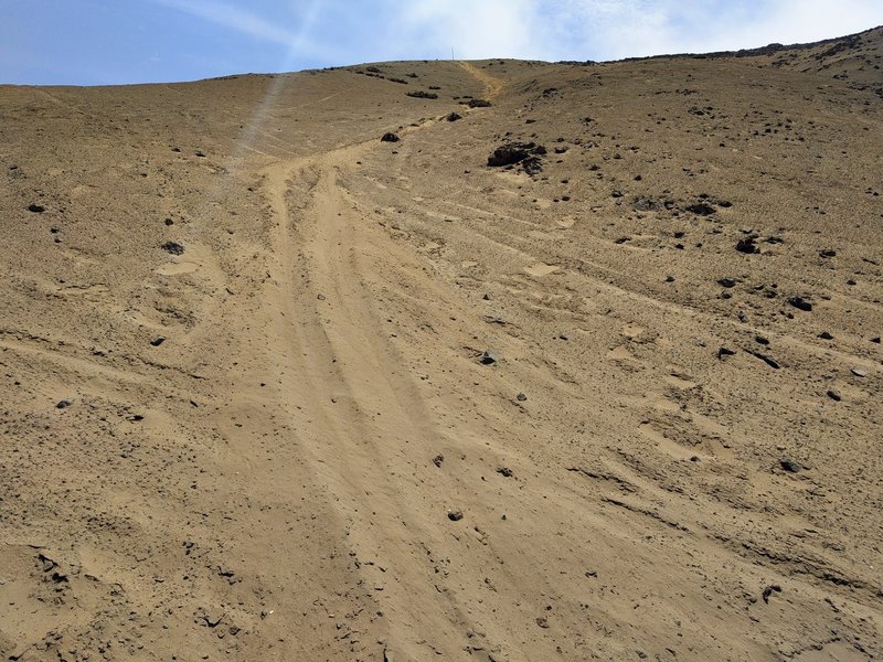 The home stretch - The large pole can be seen in this photo at the summit crest