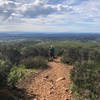 Hiker on Black Mountain, facing toward the Santaluz Club with Rancho Santa Fe in the far background.