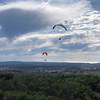 Two paragliders on the western edge of Black Mountain with Torrey Highland in the distance and the Pacific Ocean 10 miles away. Downtown La Jolla is just left of the lower paraglider.