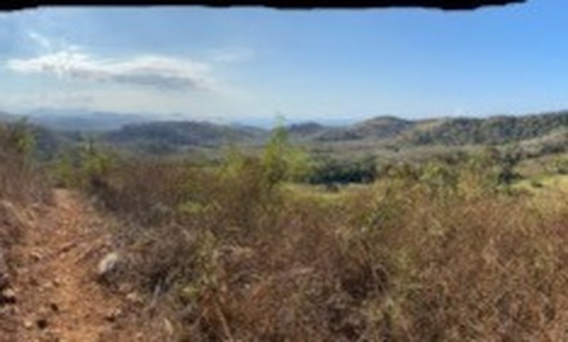 View of distant mountains and ocean from exposed area overlook