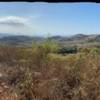 View of distant mountains and ocean from exposed area overlook