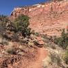 Climbing out of a wash with beautiful views of the red cliffs.