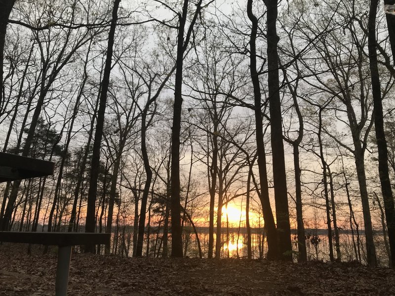 View of the sunrise and lake from camping shelter number 1 off mile 6 of the Cane Creek Trail. Actual location at about (33.94213, -91.79592).