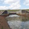 The spillway coming through the dike into Langham Creek channel, from the south side looking north.