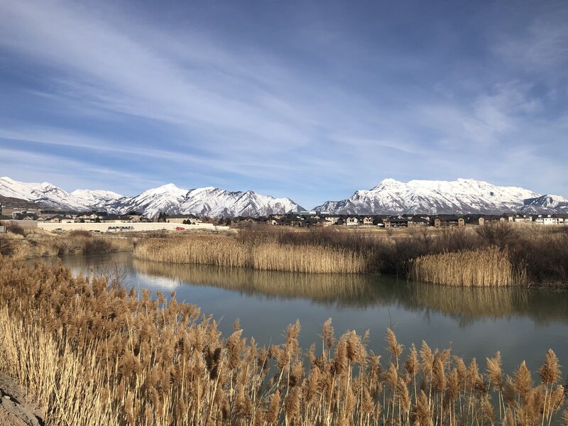 Snowcapped Wasatch mountains viewed from the Jordan River trail near Thanksgiving Point.