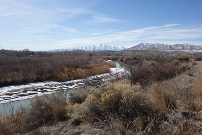 The Jordan River and the distant Oquirrh Range with snowy Flat Top Mountain in the background (center) seen on a very clear pandemic day. Latimer Point is closer, center right.