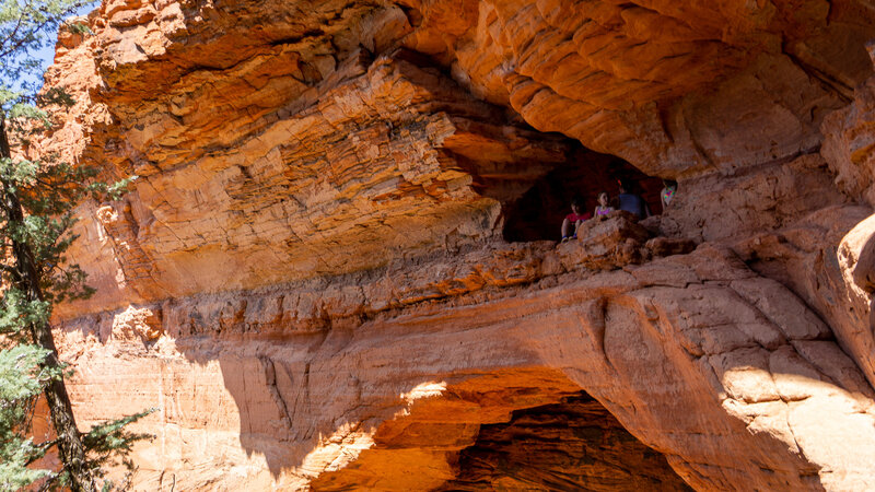 Hikers looking out from Soldier Pass Cave.