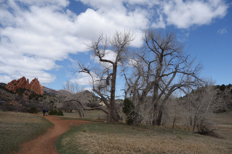 Two hikers on the Ute trail facing the Gateway Rocks at Garden of the Gods.