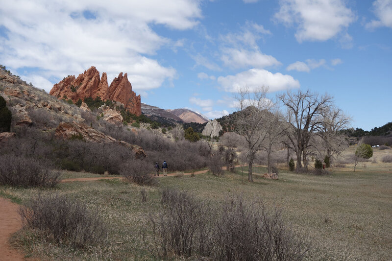 Two hikers on the Ute trail, framed by the Gateway Rocks at the Garden of the Gods.