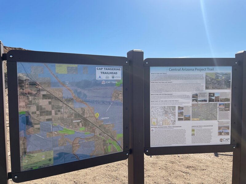 Three panels of information signage just past the main parking lot.