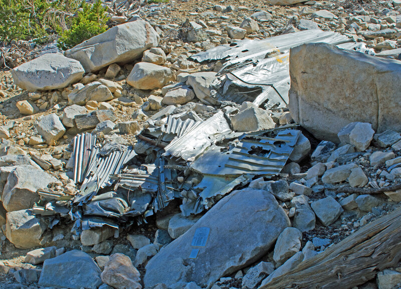 Part of wing and fuselage from an Air Force Douglas C-47 cargo plane that crashed in 1952. Note the plaque on the rock commemorating the airmen who were killed.