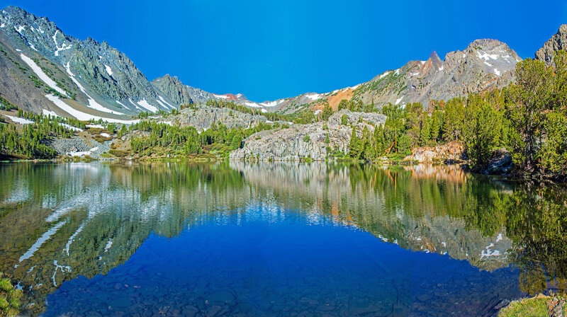 Morning reflection in Cooney Lake. Black Mountain is on the left. Burro Pass in in the center.