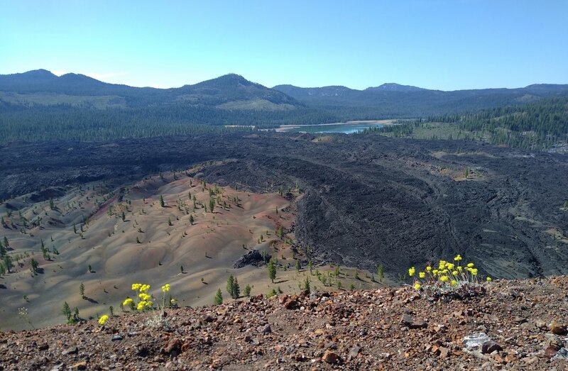 From the rim of Cinder Cone looking south-southeast: Snag Lake in the distance, Mt. Harkness behind right/south end of Snag Lake, Mt. Hoffman (upper center left), Red Cinder and Red Cinder Cone (upper left), Painted Dunes and Fantastic Lava Beds below.