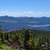 Looking southeast from the top of Prospect Peak, one can look into Cinder Cone below (center lower left). On the horizon are Red Cinder and Red CInder Cone (right center). Snag Lake (right) with Mt Hoffman nearby, behind it, are also seen.