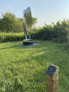 Sculpture with sign. The sculpture is titled "Position #1".